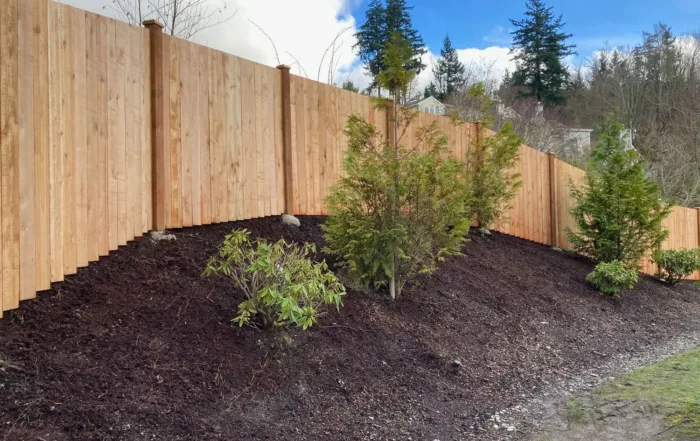 Cedar wood estate style fence with shrubs in front